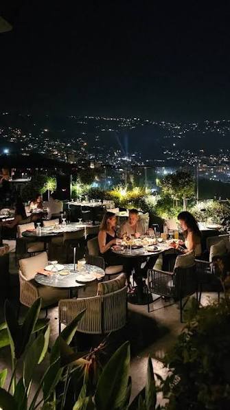 Rooftop tables overlooking Beirut at night